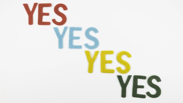 Animated stop motion video with banner YES that repeats four times in different colors: red, blue, yellow and green