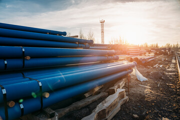 Stack of cast pipes for sewerage ready for transportation and distribution.