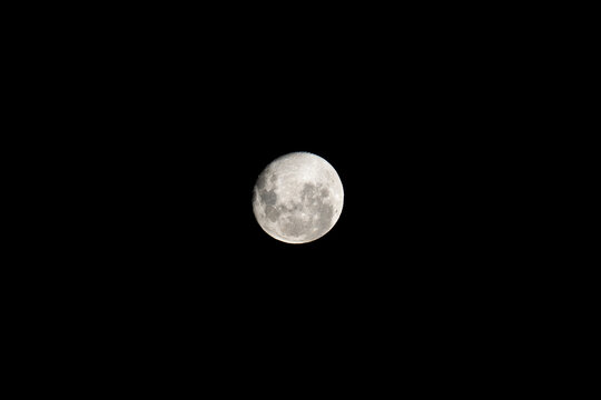Full bright moon on a black sky background 