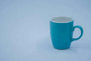 Turquoise colored porcelain cups on white background.