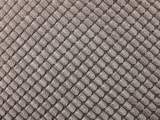 Fluffy upholstery fabric texture in beige color, close up. Light brown background of soft velour cloth
