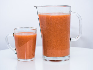 exotic fruit juice in a jug and a glass, a bright background, a healthy lifestyle