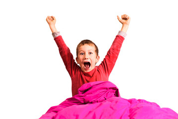 Child in his bed stretches with his mouth open, isolated on white background.