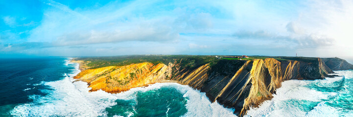 Aerial drone view of cape Cabo Espichel at sunset with cliffs and Atlantic ocean landscape. Western coast of Eurasia. Sesimbra, coastline of Portugal