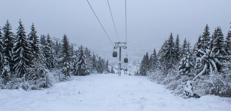 Banner. Cable car photographed from Trebevic in winter while it is snowing. Snow in winter on the mountain Trebevic. Sarajevo cable car in nature. Winter and snow.