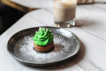 St. Patrick's Day cupcake on a dark plate on the table
