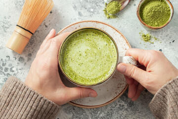 Cup of Matcha Green Tea in woman hands. Top view. flat lay