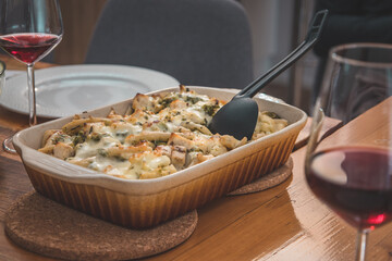 Veggie side dish from cheese, cauliflower and other vegetables served on a wooden table at a celebration.