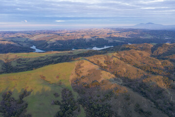 The last light of day illuminates the green, rolling hills just east of San Francisco Bay. This entire region turns green after winter storms bring rain.