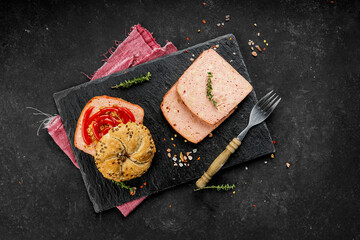 Flat lay composition of delicious hot dogs and sandwiches with different toppings on the dark background