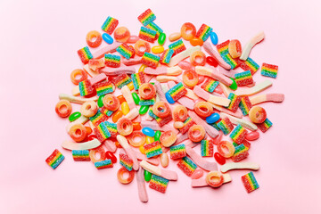 Mixed collection of colorful candy, on pink background. Flat lay, top view