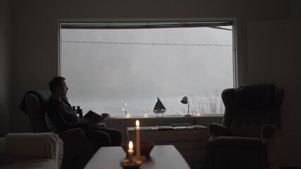Comfortable Man Looking Out Of Window To Fjord