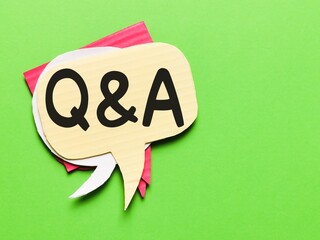 Q and A concept.Top view colorful bubble speech stacked together written Q and A isolated on green background.