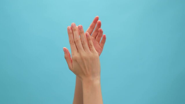 Close up of hand clapping on the blue background. celebration concept.