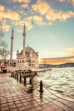 Beautiful Istanbul landscape. Sunrise near Bosphorus bridge (aka: 15 July Martyrs Bridge. Turkish: 15 Temmuz Sehitler Koprusu). Storm near Grand Imperial Mosque of Sultan Abdulmecid in Ortakoy, Turkey