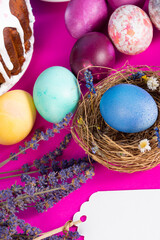 Colorful background with Easter eggs on pink background. Happy Easter concept. Can be used as poster, background, holiday card. Flat lay, top view, copy space. Studio Photo