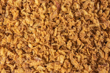 Crispy carmelized fried onion flakes background. Spices and food ingredients.