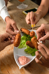 Chicken croquettes in open-air restaurants, being tasted