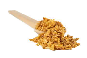 Crispy carmelized fried onion flakes in wooden spoon isolated on white background. Spices and food ingredients.