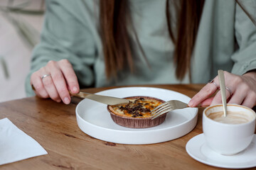 woman cuts her mushroom quiche to eat it
