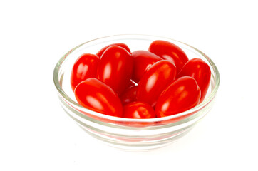 Small red oval cocktail cherry tomatoes on white background. Studio Photo