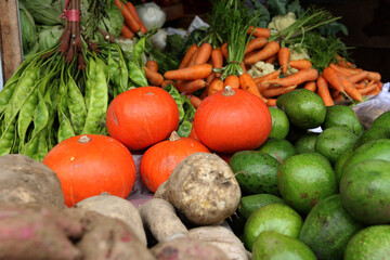 Kinds of vegetables and fruit in a traditional shop. There are carrots, bitter beans, pumpkin, yams, avocados. Focus Selected