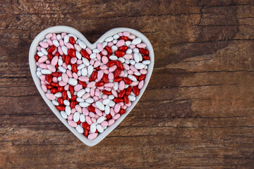 Candy coated sunflower seeds, red, pink, and white, in a heart shaped ceramic dish, Happy Valentines Day
