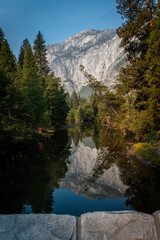 Fototapeta na wymiar Cliff reflects in still river at Yosemite