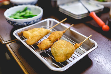 Kushikatsu (traditional vegetables fried with tempura) and edamame green beans, Osaka, Japan