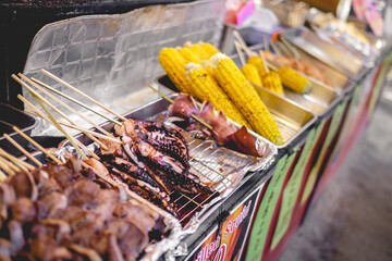 Traditional food stall with octopus, skewers, corn, sausage, etc. at Miyajima Island, Japan