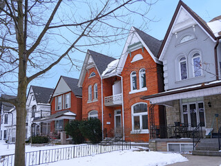 Residential street with older semidetached houses with gables