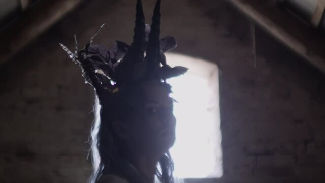 Azazel With Goat Horn Headdress Rising In Attic
