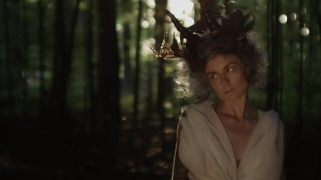 Woman With Goat Horn Headdress In Forest