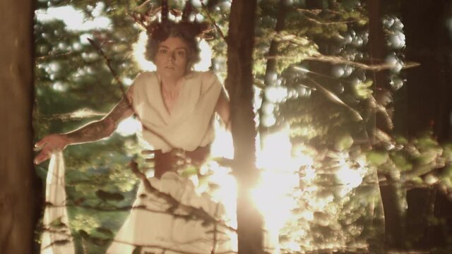 Woman In Headdress And White Dancing In Forest