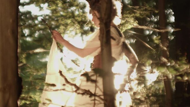 Woman In Headdress Dancing In Sunlit Forest