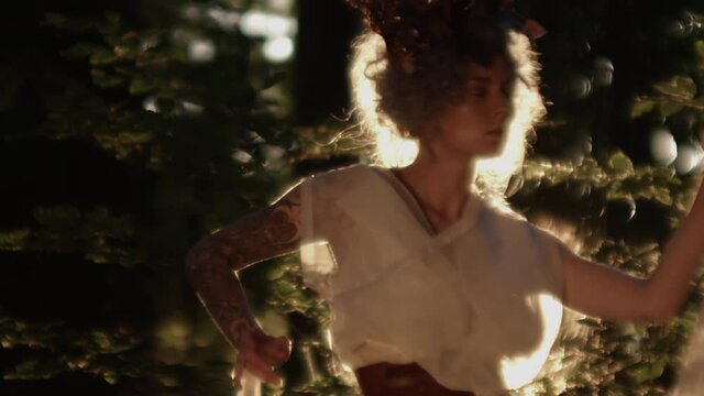 Woman Dressed As Azazel Dancing In Sunlit Forest