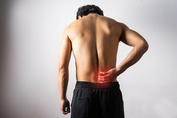A portrait of a man touching a painful back