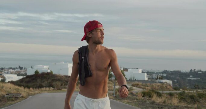 Slim Man In Backwards Cap On Road