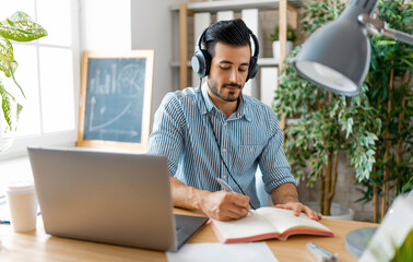 man working on a laptop at home.