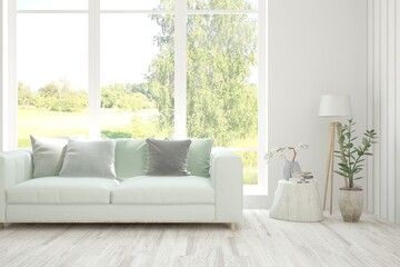 White living room with sofa and summer landscape in window. Scandinavian interior design. 3D illustration