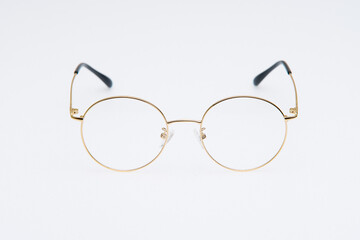 Fototapeta premium Fashion sunglasses golden frames on white background.