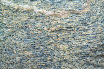 Dark blue and pink granite untreated surface. Natural background. Stone texture.