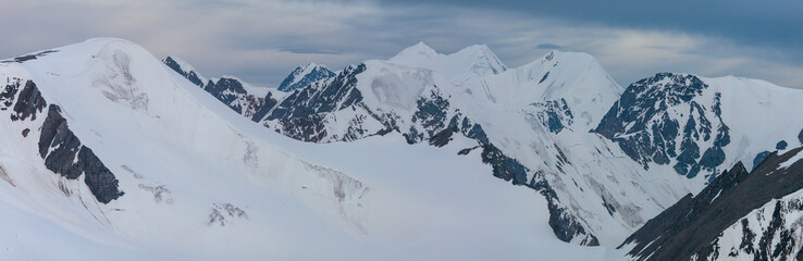Panoramic mountain view. Snow-capped peaks and glaciers.