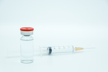 Vaccine bottle dose with drug needle syringe on white background. Injection treatment flu disease care hospital prevention virus. Immunity chemistry research in the lab. Covid-19, Coronavirus concept.