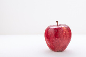The apple is red-yellow, juicy on a light background