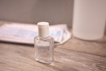 Hand sanitizer and medical surgical masks for Covid-19 Coronavirus prevention close up.