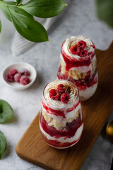 Trifle with raspberries and whipped cream on the table.