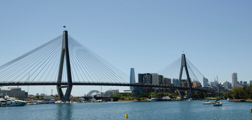 Glebe Island Bridge with Sydney Harbour Bridge, Crown Tower and city skyline from Blackwattle Bay, Sydney, New South Wales, Australia
