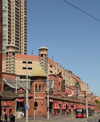 Outside Market City in Hay Street, Haymarket, Sydney, Australia with light rail and signs celebrating Chinese New Year
