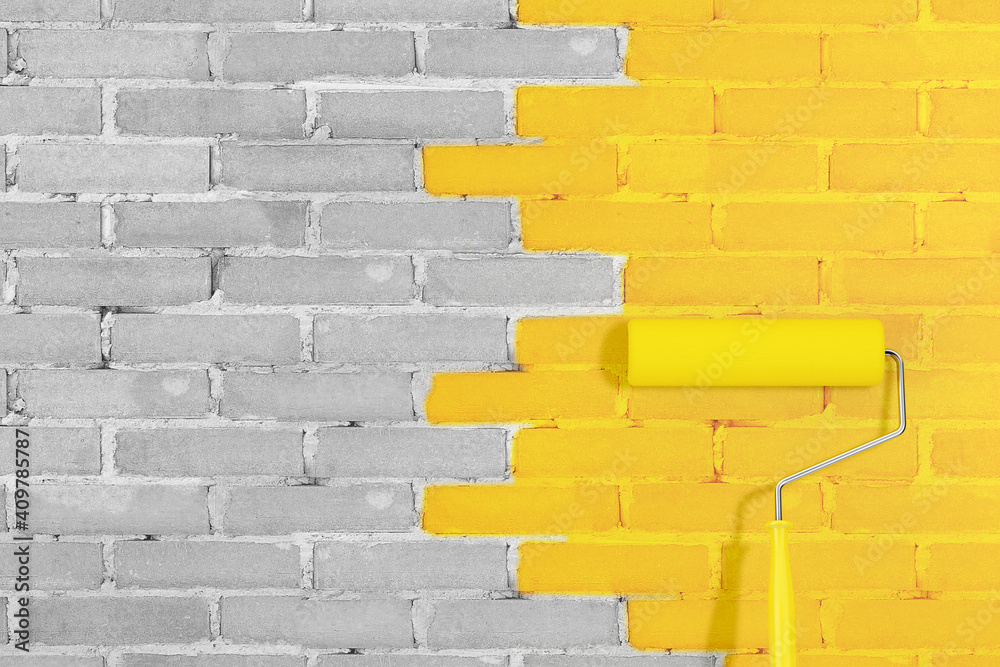 Poster brick wall with paint roller in yellow illuminating and ultimate gray main trendy colors of the year